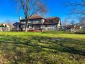 Expansive backyard with a well-maintained lawn, wooden deck, and a fence line, perfect for outdoor activities at 7211 Kensington Ct, Avon, IN 46123