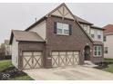 View of a well maintained home with an attached two car garage and manicured lawn at 7730 Imperial Eagle Dr, Zionsville, IN 46077