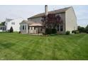 Spacious backyard with lush green grass, patio, and mature trees perfect for outdoor activities at 8358 Balmoral Dr, Avon, IN 46123