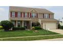 Traditional two-story home with red shutters, well-kept lawn, and attached garage at 8358 Balmoral Dr, Avon, IN 46123