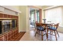 Cozy breakfast nook featuring a fireplace, tile flooring, a round wooden table, and a sliding door to the patio at 8737 Champions Dr, Indianapolis, IN 46256
