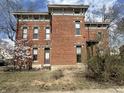 Two-story brick home with intricate architectural details, offering a classic and timeless appeal with blossoming trees at 902 N Broadway St, Indianapolis, IN 46202