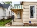 A covered front porch entry with security features, and an awning above the door at 902 Villa Ave, Indianapolis, IN 46203
