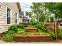 Backyard garden with raised garden beds and a charming picket fence surrounding the property at 902 Villa Ave, Indianapolis, IN 46203