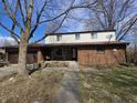 Charming home with a mix of brick and siding, front porch, and two-car garage at 930 Charlene Ln, Anderson, IN 46011