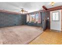 Spacious living room features carpet, decorative wallpaper, and lots of natural light at 9406 Northeastern Ave, Indianapolis, IN 46239