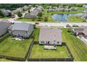 Aerial view of backyard, deck, and neighborhood pond adds beauty to the community at 10522 Hunters Crossing Blvd, Indianapolis, IN 46239