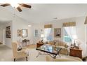 Bright living room with neutral tones, featuring a ceiling fan, and two large windows at 10629 Medinah Dr # 1, Indianapolis, IN 46234