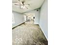 Open-concept living space with gray walls and carpet at 1100 Graham St, Franklin, IN 46131
