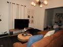 Bright living room with an ornate ceiling lamp fixture and decorative wall art at 1153 W 29Th St, Indianapolis, IN 46208