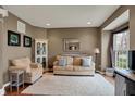 Comfortable living room featuring a neutral palette, area rug, and ample natural light at 11629 Boothbay Ln, Fishers, IN 46037