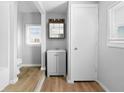 Cozy bathroom featuring a modern vanity, wood-look flooring, and neutral paint at 1313 W Memorial Dr, Muncie, IN 47302