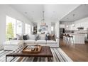 Open-concept living space featuring a comfortable sectional sofa, vaulted ceilings, and seamless kitchen access at 15250 Mooring E Cir, Carmel, IN 46033