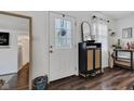 Charming entryway featuring a decorative glass door, modern storage cabinet, and dark wood flooring at 15473 Martha St, Fortville, IN 46040