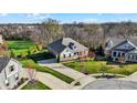 An aerial view showcases this home nestled on a verdant lot, surrounded by mature trees at 15509 Slateford Rd, Noblesville, IN 46062