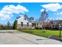 Beautiful home with a well-maintained lawn, complemented by a long driveway and mature trees at 15509 Slateford Rd, Noblesville, IN 46062