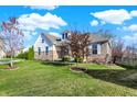 Attractive home with a lush lawn, complemented by young trees and professional landscaping at 15509 Slateford Rd, Noblesville, IN 46062