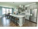 Open-concept kitchen with quartz island, modern appliances, and adjacent dining area at 15958 Oakhurst Ln, Fishers, IN 46040