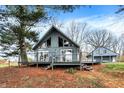 Stylish A-frame home boasting a large deck, perfect for outdoor entertaining and enjoying nature at 2025 State Road 47, Lebanon, IN 46052
