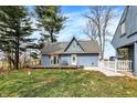 Charming blue home with a deck, white picket fence, and well-maintained lawn on a sunny day at 2025 State Road 47, Lebanon, IN 46052
