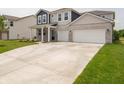 Wide driveway leading to a lovely two-story home with a three-car garage at 211 Ames Dr, Whiteland, IN 46184