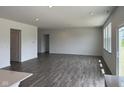 Spacious living room with hardwood floors, recessed lighting, and a sliding glass door at 211 Ames Dr, Whiteland, IN 46184