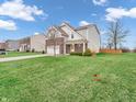 A front yard view of this home with a partial view of the lawn and landscaping at 2207 Mcgregor Ct, Avon, IN 46123