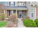 Inviting front porch with brick facade and a swing at 2209 Foxfire Ct, Greenfield, IN 46140