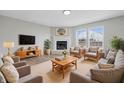 Bright living room features a fireplace, new floors, neutral paint, and multiple seating options at 2405 Providence Ct, Greenwood, IN 46143