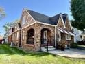 Two-story brick home with stone accents, arched porch, and manicured lawn at 303 S Walnut St, Edinburgh, IN 46124