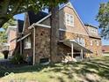 Back of the home featuring brick facade, well maintained yard, and mature trees at 303 S Walnut St, Edinburgh, IN 46124
