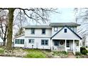 Two-story home boasts a welcoming front porch, well-maintained lawn, and mature trees at 3030 N 600 E, Lebanon, IN 46052
