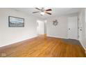 Bright living room with hardwood floors, ceiling fan, neutral paint and entry to other rooms at 3104 S Pisgah Way, Columbus, IN 47203