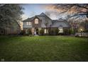 Inviting two-story home with brick and siding facade and a spacious green front lawn at 325 W Greyhound Pass, Carmel, IN 46032
