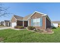 Well-maintained home featuring a brick facade and manicured landscaping at 3254 S Ansley Dr, New Palestine, IN 46163