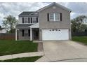 Charming two-story home featuring a brick facade, well-manicured lawn, and a two-car garage at 373 Springfield Cir, Greenwood, IN 46143