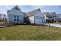 Beautiful home with brick exterior, three car garage, and a lush green lawn at 4034 Saddle Club S Pkwy, Bargersville, IN 46106