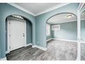 Bright, airy living room showcasing gray floors, an arched doorway, and white trim at 420 N Irvington Ave, Indianapolis, IN 46219