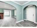 Inviting living room featuring new gray floors, arches, and a white front door at 420 N Irvington Ave, Indianapolis, IN 46219