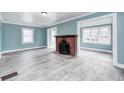 Spacious living room featuring gray floors, a fireplace, and abundant natural light at 420 N Irvington Ave, Indianapolis, IN 46219