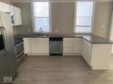 Well-lit kitchen with modern stainless steel appliances, and gray countertops at 430 Parkway Ave, Indianapolis, IN 46225