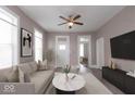 Cozy living room with neutral tones, a ceiling fan, and plenty of natural light at 430 Parkway Ave, Indianapolis, IN 46225