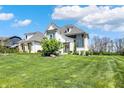 Charming two-story residence with lush lawn featuring established landscaping and inviting front entrance at 5130 Melbourne Pl, Zionsville, IN 46077