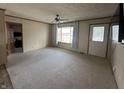 Inviting living room with carpet, a ceiling fan, and a large window filling the room with natural light at 529 E Jackson St, Martinsville, IN 46151