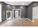 Bright living room with hardwood floors, modern gray walls, and a view of the outdoors at 555 N Hamilton Ave, Indianapolis, IN 46201