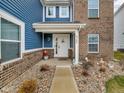 Inviting front entrance with a white door, stylish decor, and manicured landscaping at 5788 Terracotta Trce, McCordsville, IN 46055
