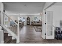 Open concept living area featuring hardwood floors, a dining area, and a cozy seating arrangement at 5788 Terracotta Trce, McCordsville, IN 46055