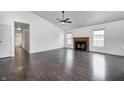 Large living room with a fireplace, hardwood floors, and abundant natural light at 6036 Terrytown Pkwy, Indianapolis, IN 46254