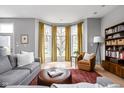Bright living room with hardwood floors, large windows, comfortable seating, and stylish decor at 634 N Senate Ave, Indianapolis, IN 46202