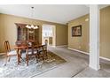 Dining room features a wood table and chairs, a china cabinet, and is located adjacent to the living room and kitchen at 639 Nuttal St, Westfield, IN 46074